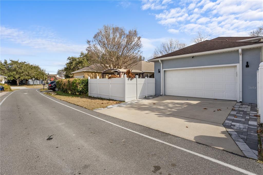 6911 Beargrass Road Harmony, FL 34773 - Photo 40 of 60 a front view of a house with a yard and garage