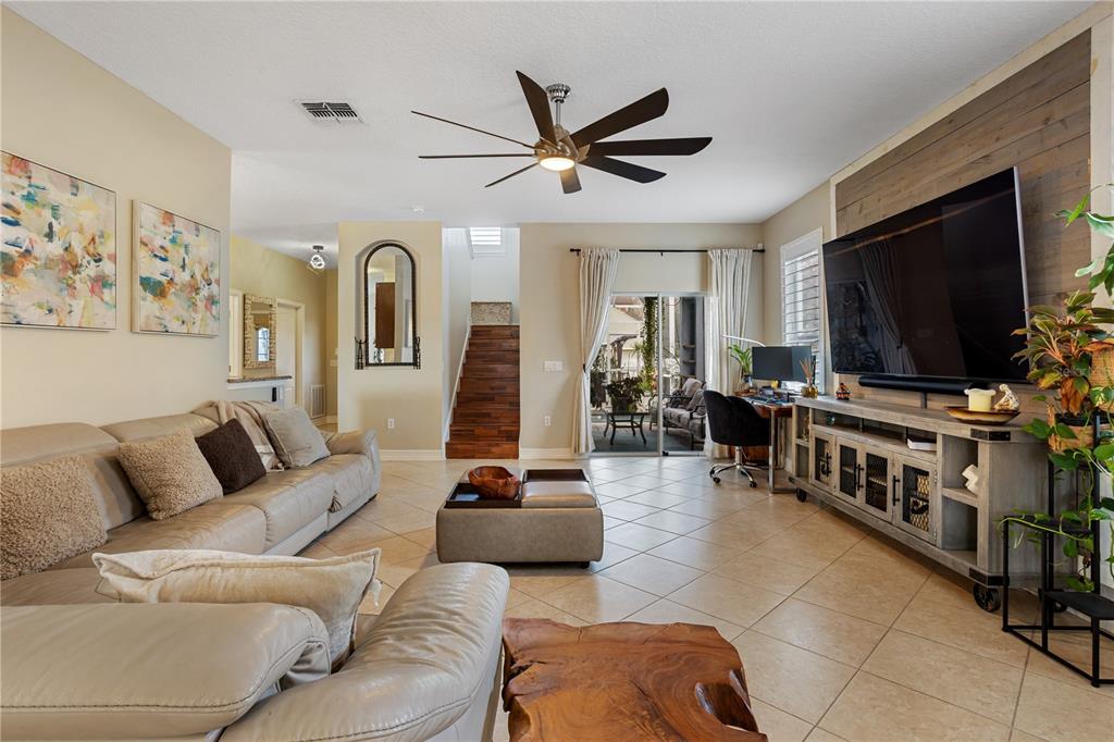 6911 Beargrass Road Harmony, FL 34773 - Photo 7 of 60 a living room with furniture and a flat screen tv