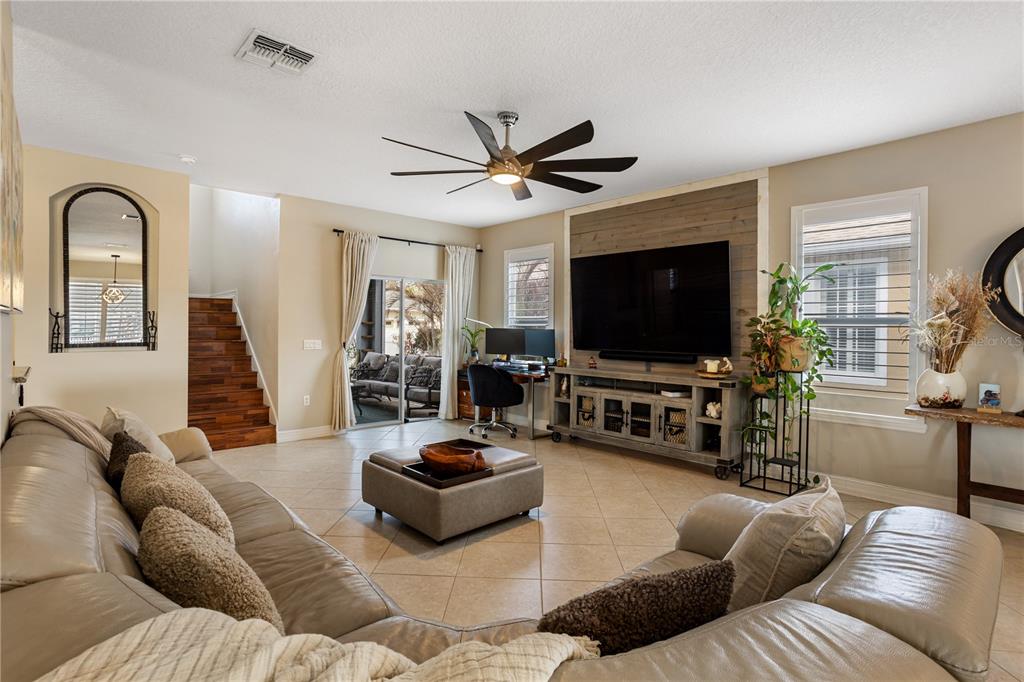 6911 Beargrass Road Harmony, FL 34773 - Photo 8 of 60 a living room with furniture and a flat screen tv