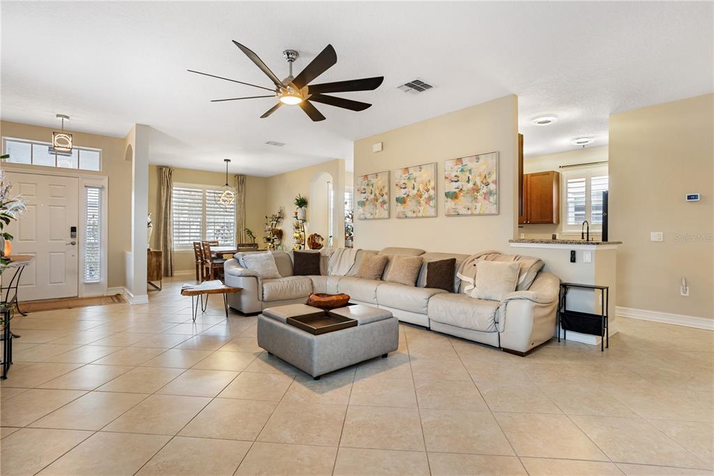 6911 Beargrass Road Harmony, FL 34773 - Photo 10 of 60 a living room with furniture and a view of kitchen
