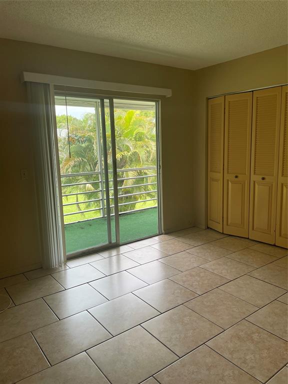 387 Tilford R, Unit 387 Deerfield Beach, FL 33442 - Photo 7 of 53 a view of an empty room with a fireplace and a window