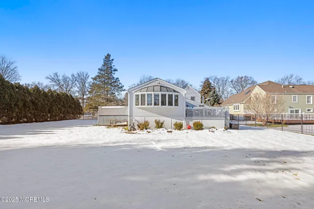 a view of a house with a snow on the road