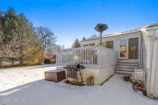 a view of a roof deck with a small yard and a fire pit