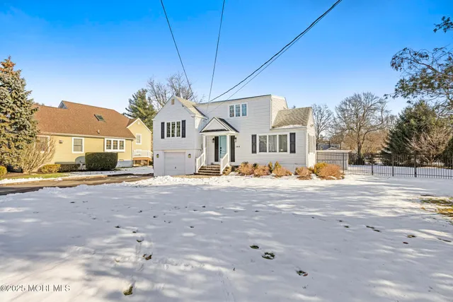 a front view of a house with a road
