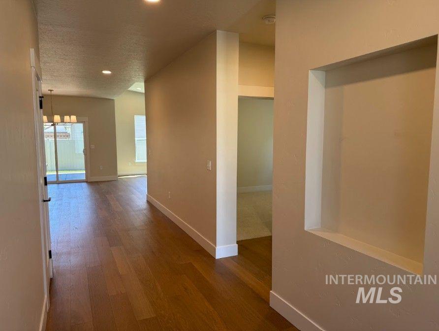683 West Wrangler Street Meridian, ID 83646 - Photo 5 of 23 Foyer featuring wood-finish flooring, recessed lighting, and a built-in wall niche