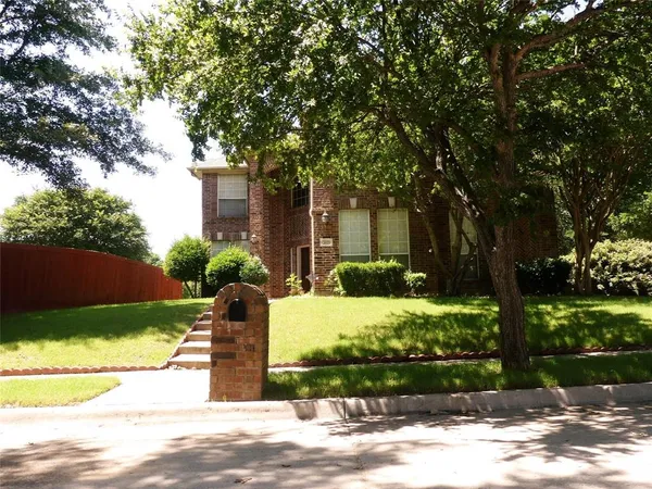 a front view of a house with parking space
