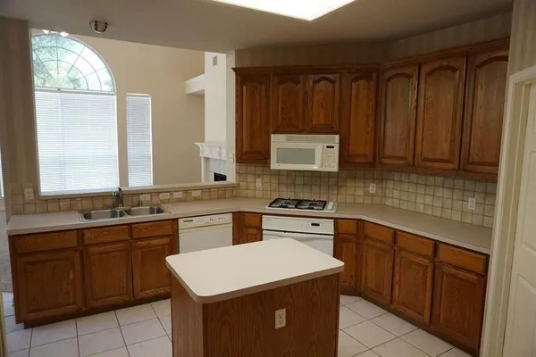 a kitchen with a sink stove and cabinets
