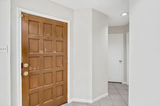 a bathroom with a granite countertop sink a toilet and a mirror