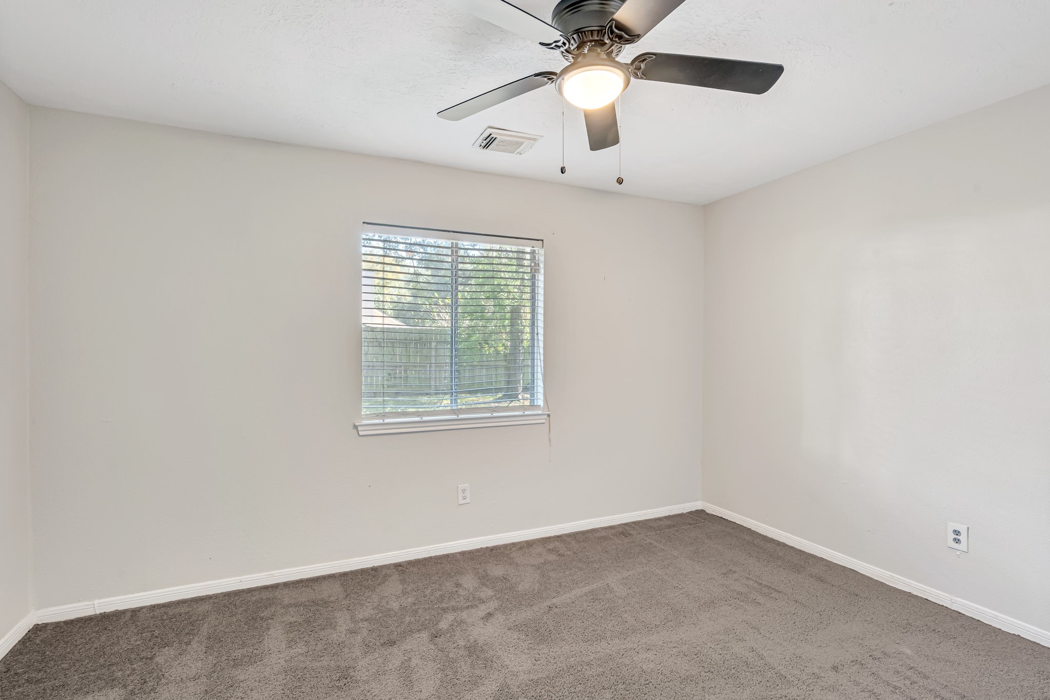 16722 Shrub Oak Drive Humble, TX 77396 - Photo 15 of 30 an empty room with a window and a fan