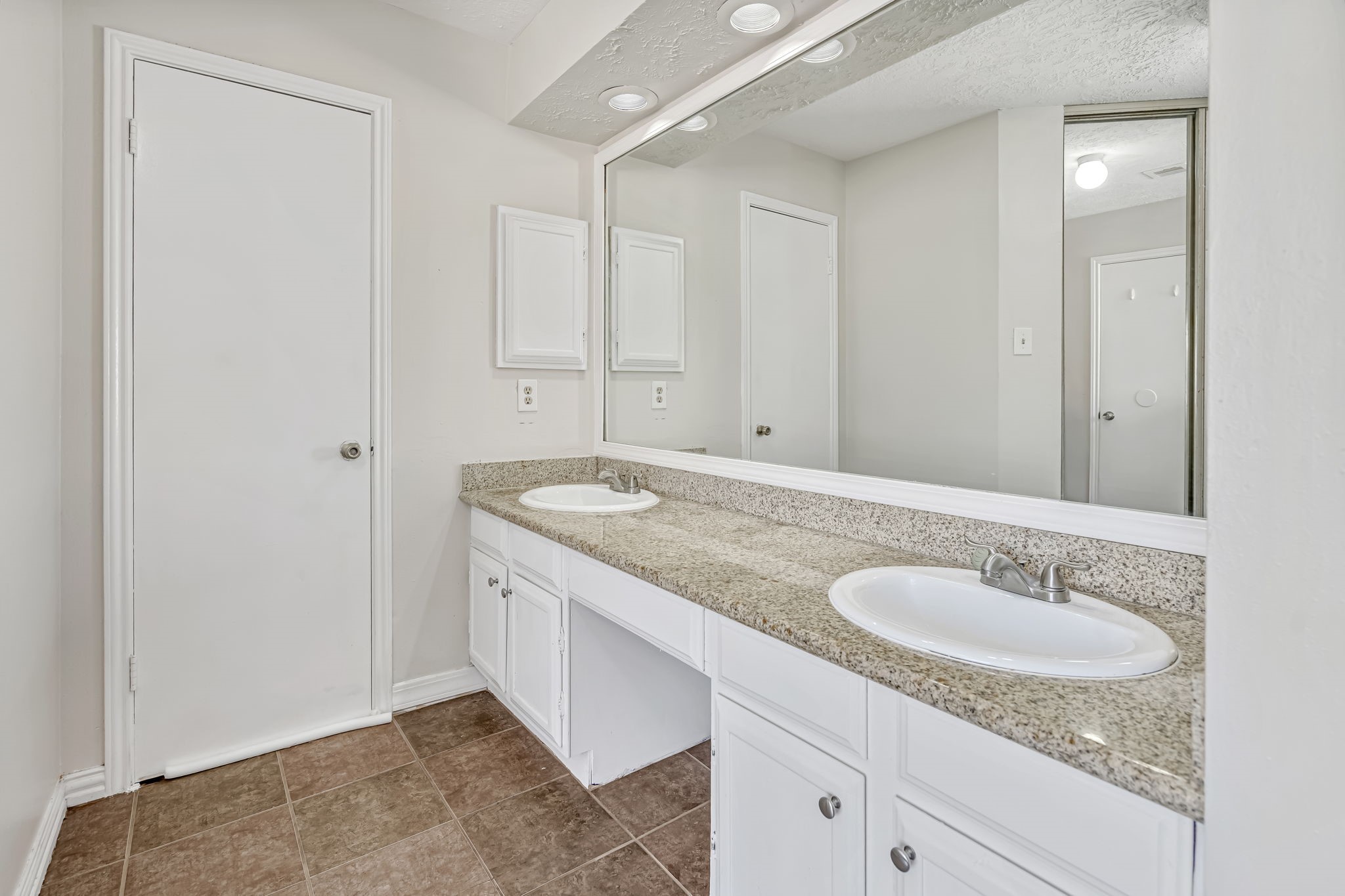 16722 Shrub Oak Drive Humble, TX 77396 - Photo 24 of 30 a bathroom with a granite countertop sink and a mirror