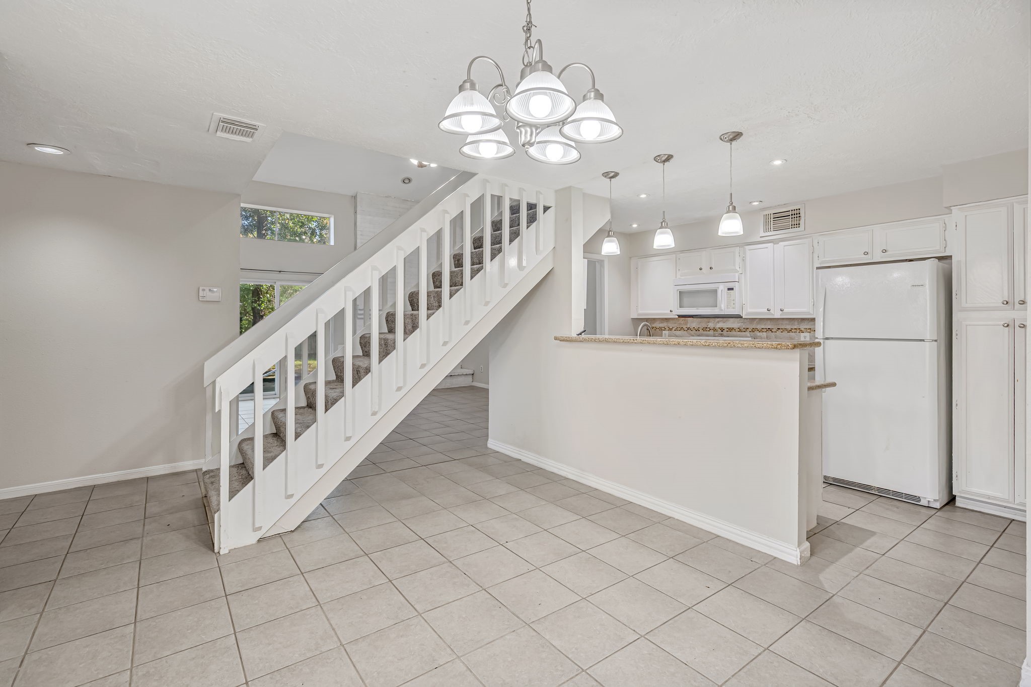 16722 Shrub Oak Drive Humble, TX 77396 - Photo 4 of 30 a view of a kitchen with an entryway and wooden floor