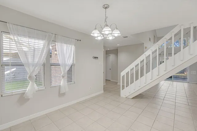 a kitchen with a refrigerator a sink and cabinets
