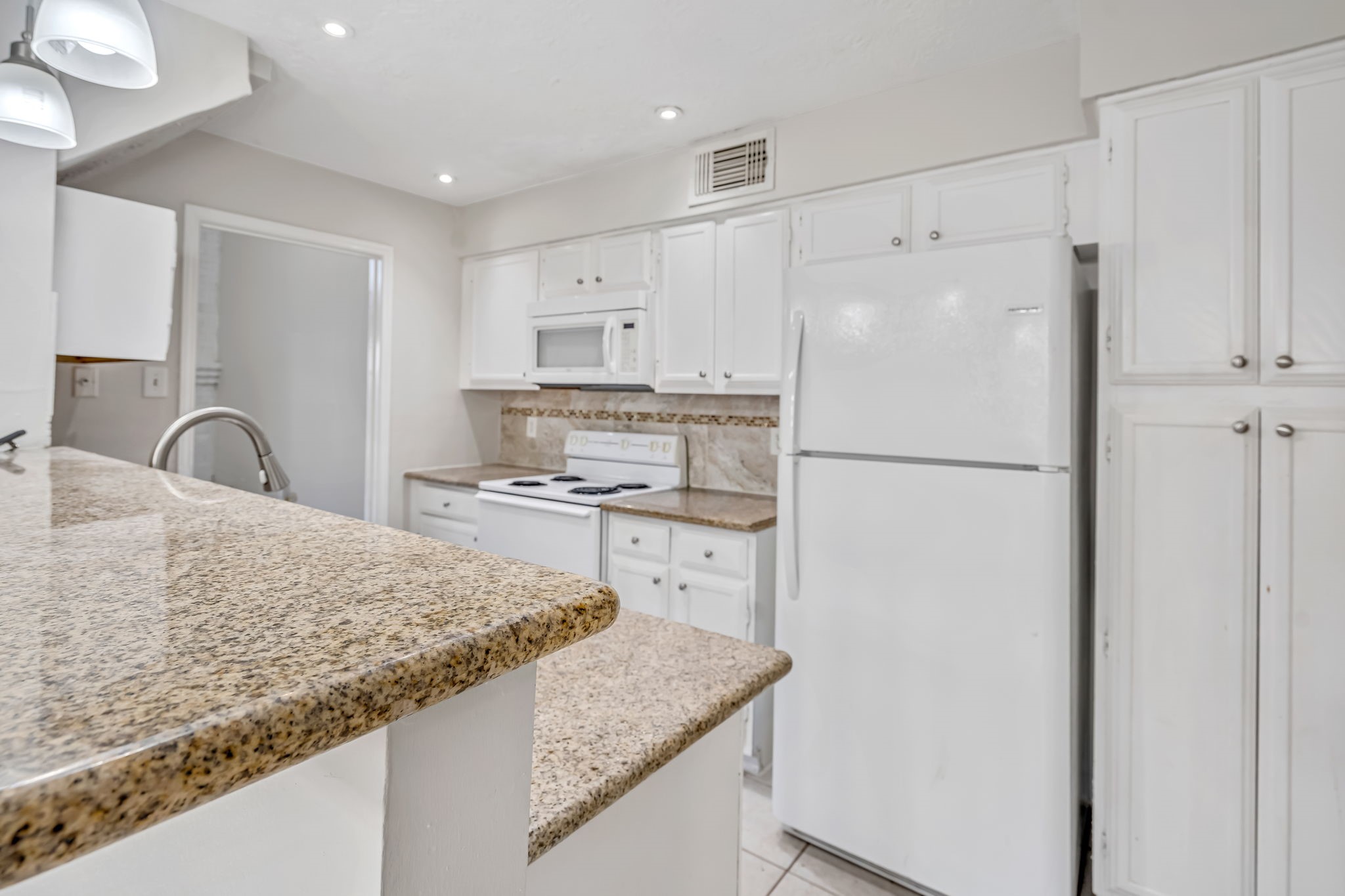 16722 Shrub Oak Drive Humble, TX 77396 - Photo 6 of 30 a kitchen with a refrigerator a sink and cabinets