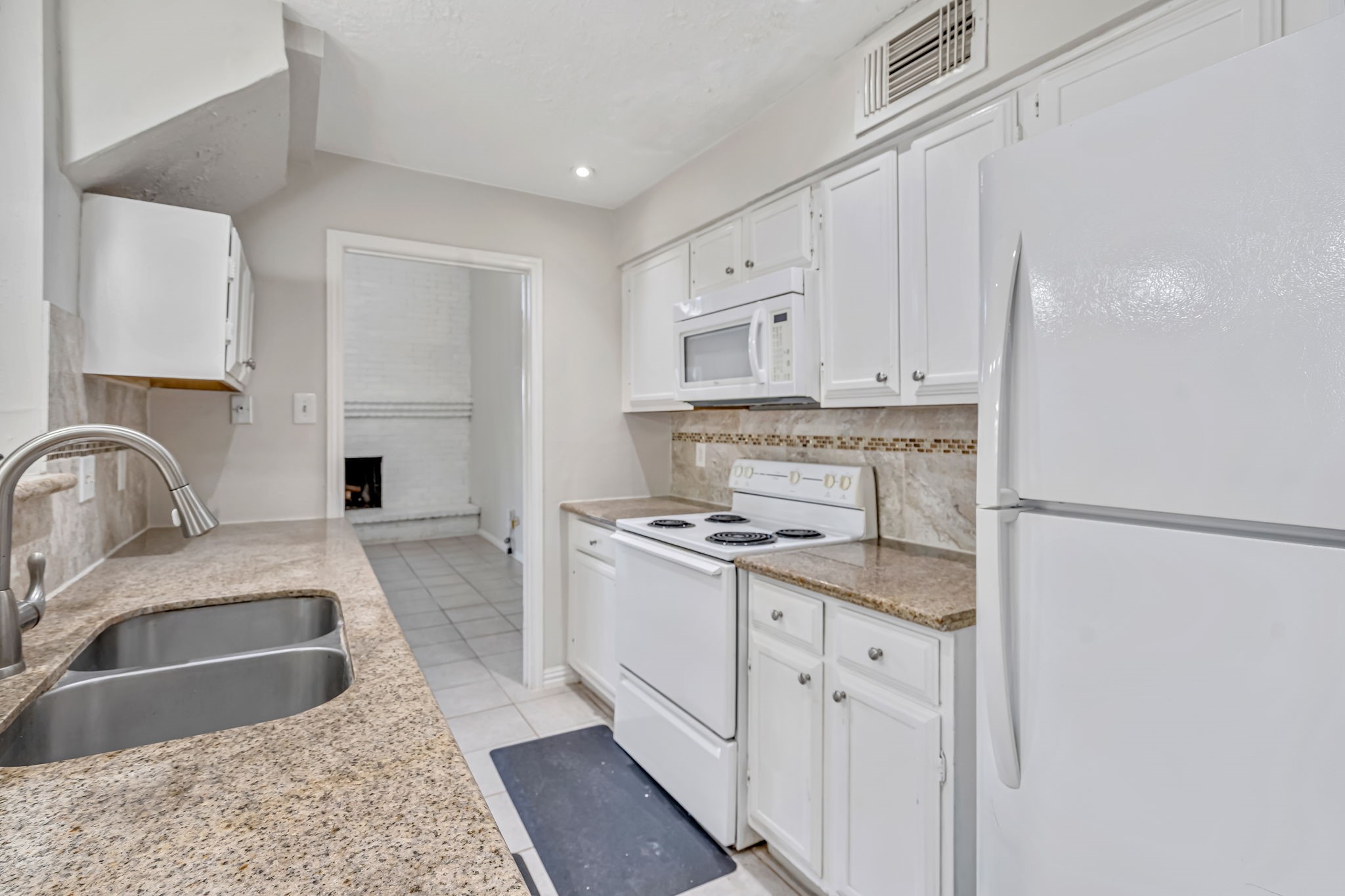 16722 Shrub Oak Drive Humble, TX 77396 - Photo 7 of 30 a kitchen with stainless steel appliances granite countertop a sink stove and refrigerator