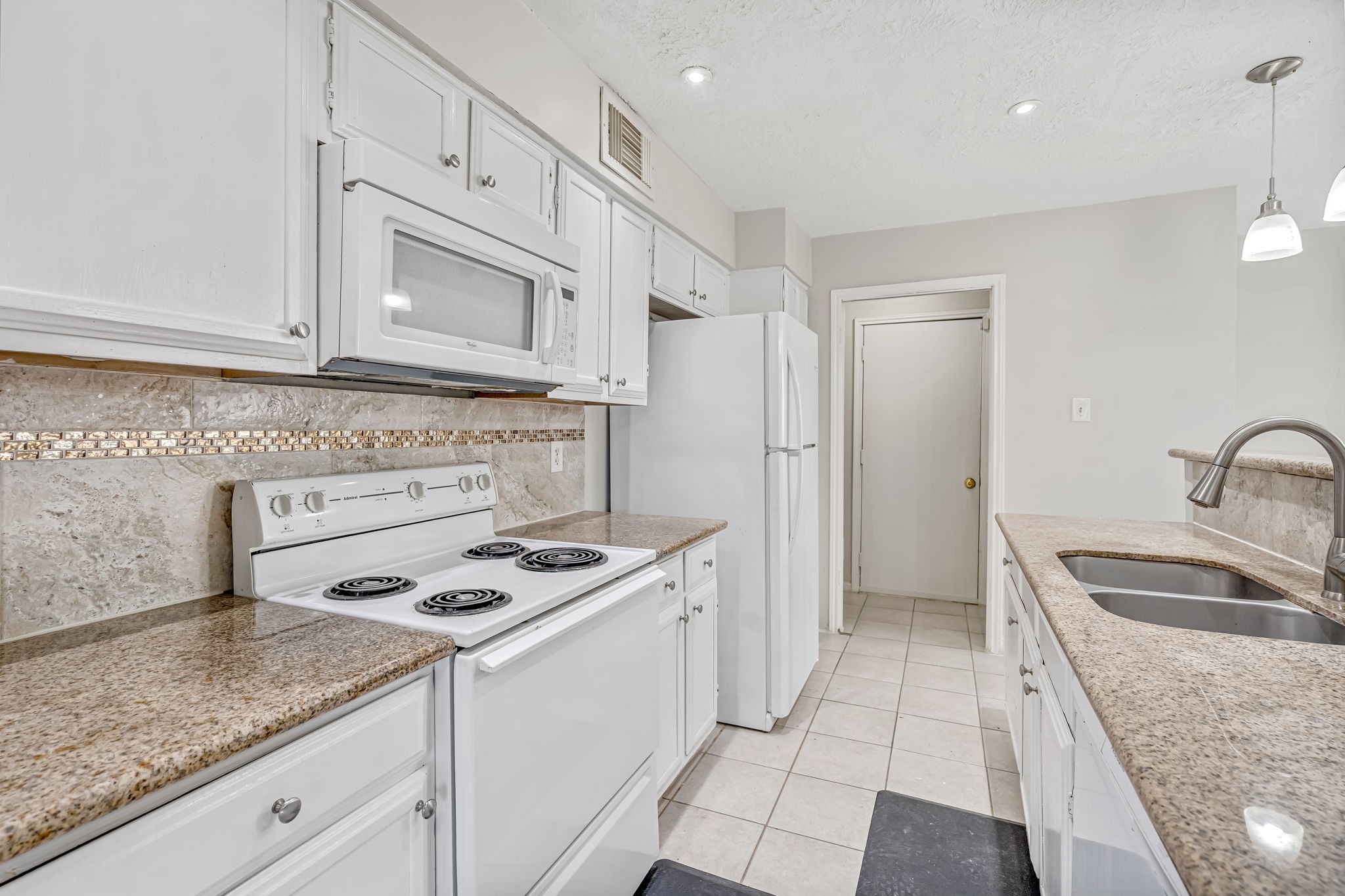 16722 Shrub Oak Drive Humble, TX 77396 - Photo 8 of 30 a kitchen that has a sink a stove and a refrigerator