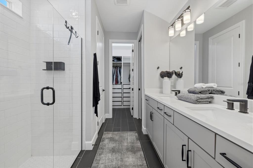 3508 Anchor Bay Trail Lakewood Ranch, FL 34211 - Photo 22 of 74 a bathroom with a double vanity sink a large mirror of shower