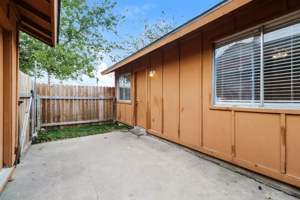 a view of backyard with small cabin and wooden fence