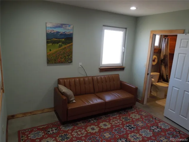 a living room with furniture and a rug