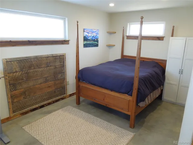 a bedroom with a bed and window