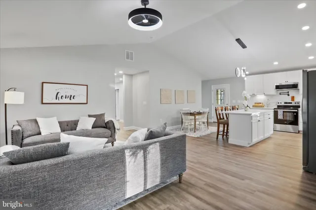 a living room with furniture and kitchen view