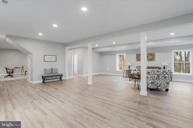 a kitchen with kitchen island granite countertop a sink a counter space stainless steel appliances and cabinets