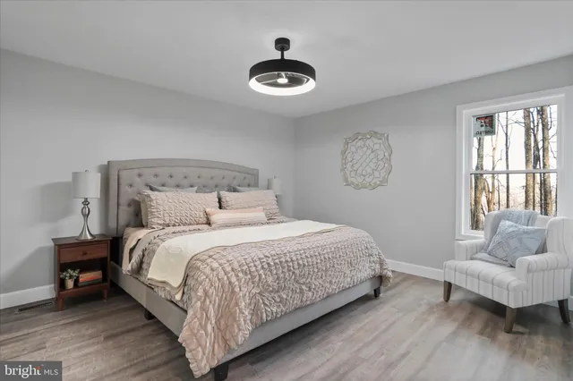 a bedroom with a bed and a chandelier