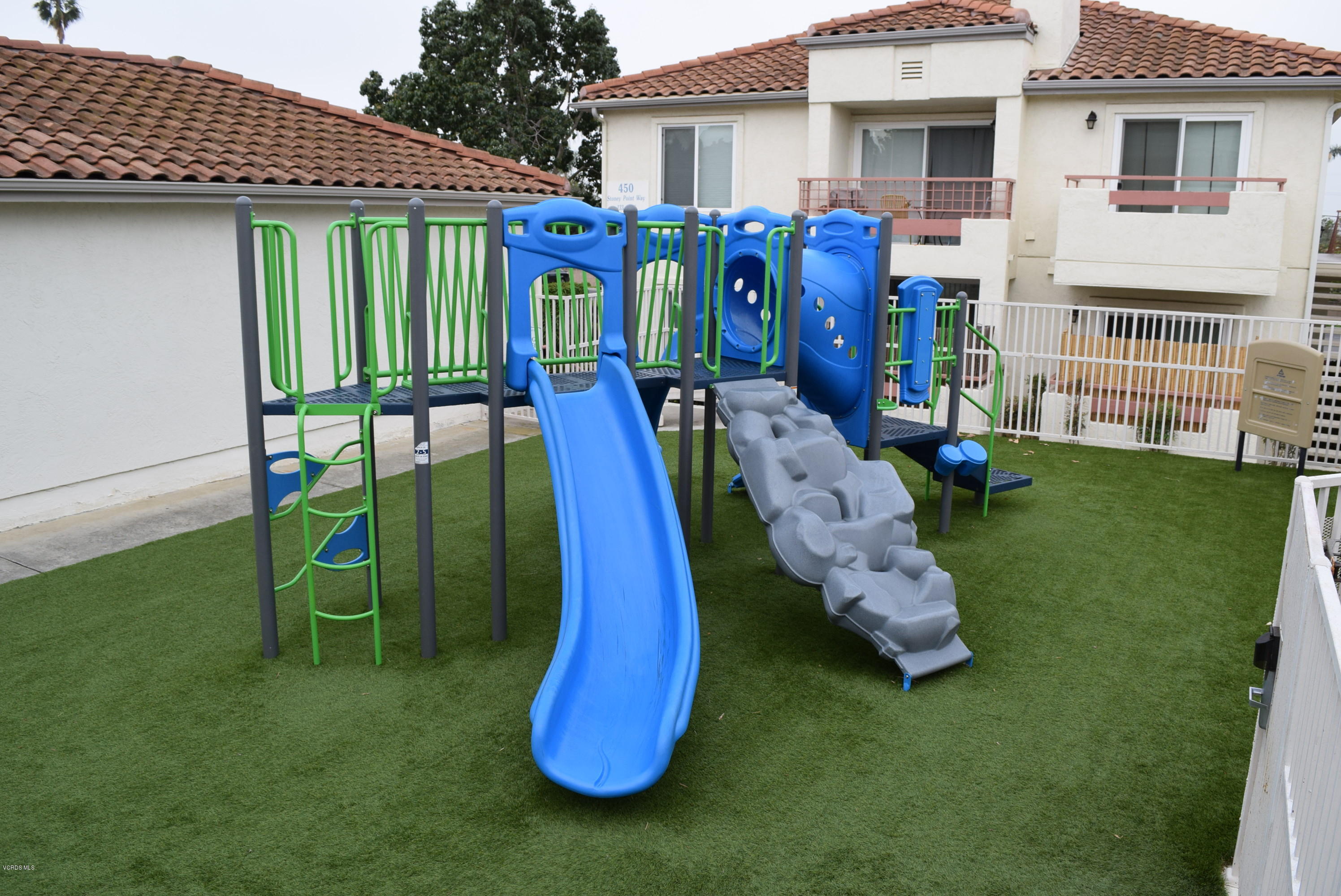 540 Ribbon Beach Way, Unit 296 Oceanside, CA 92058 - Photo 16 of 28 a front view of a house with a yard table and chairs