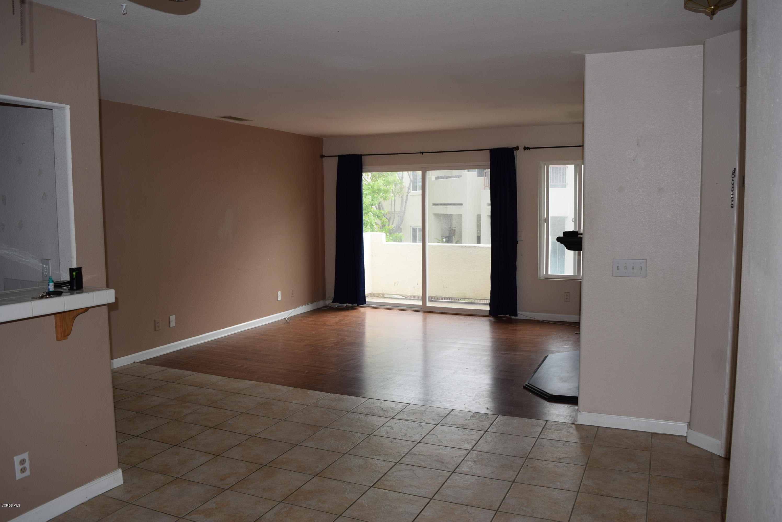 540 Ribbon Beach Way, Unit 296 Oceanside, CA 92058 - Photo 4 of 28 a view of an empty room with window and wooden floor