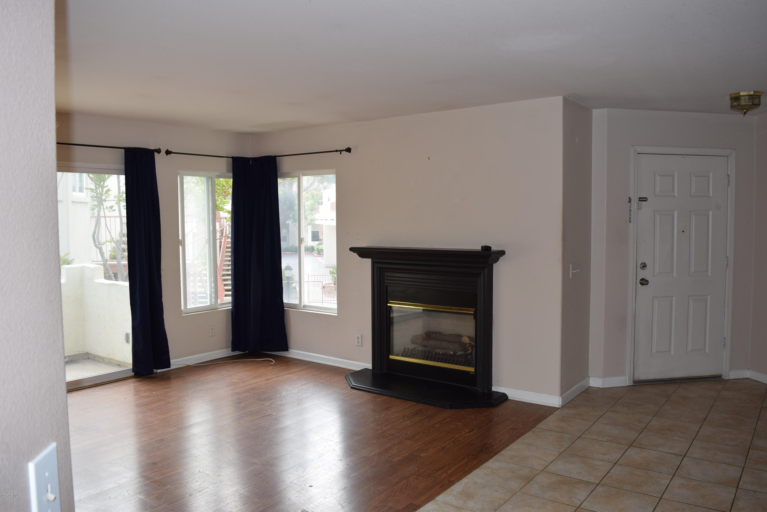 540 Ribbon Beach Way, Unit 296 Oceanside, CA 92058 - Photo 6 of 28 a view of an empty room with window and fire place