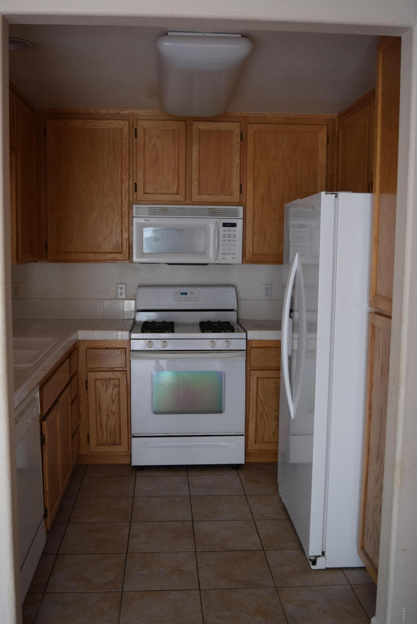 540 Ribbon Beach Way, Unit 296 Oceanside, CA 92058 - Photo 7 of 28 a kitchen with a stove top oven and refrigerator