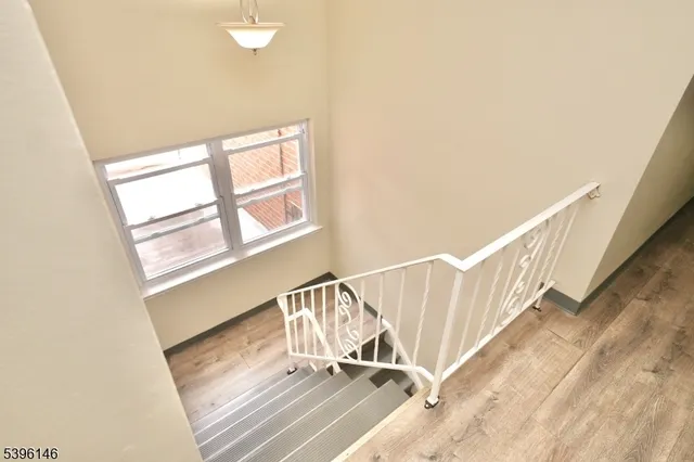 a view of staircase with white walls and a window