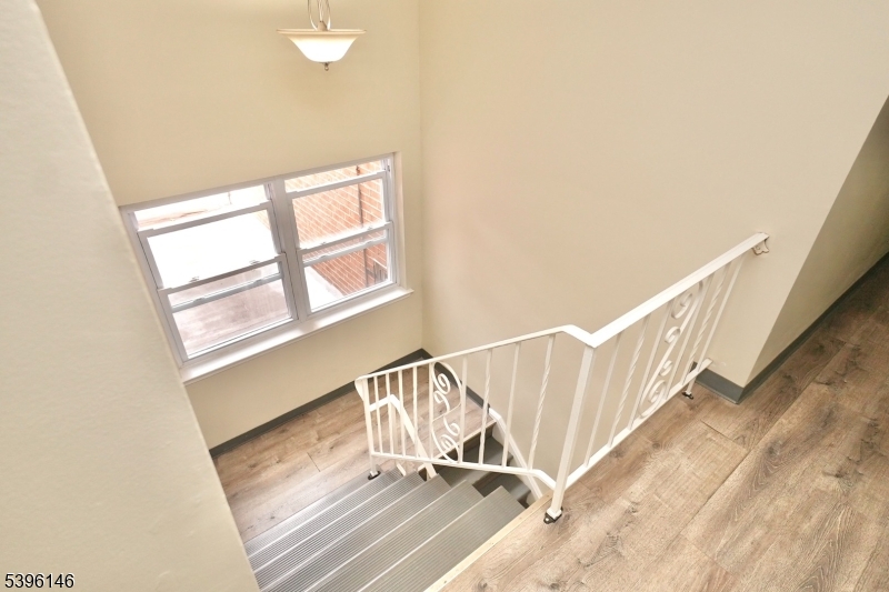 114 32nd Street, Unit 30 Union City, NJ 07087 - Photo 12 of 20 a view of staircase with white walls and a window
