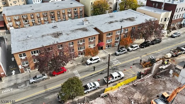 an aerial view of a swimming pool with outdoor seating space