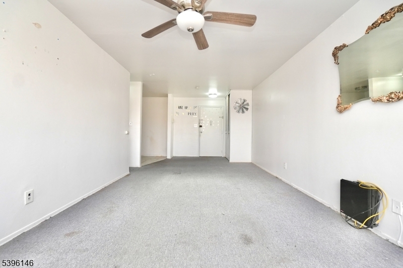 114 32nd Street, Unit 30 Union City, NJ 07087 - Photo 4 of 20 a view of a livingroom with a ceiling fan and window