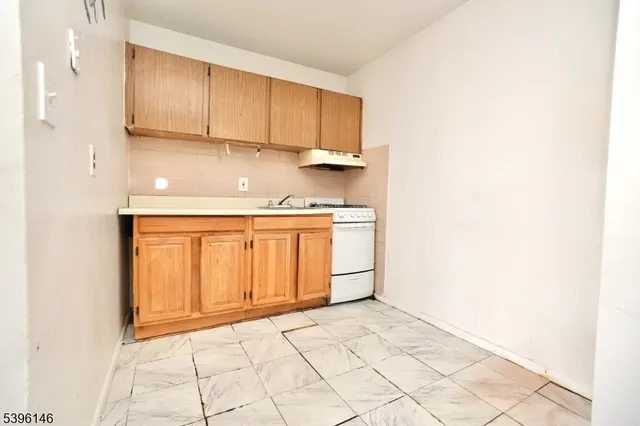 a view of a kitchen with white cabinets