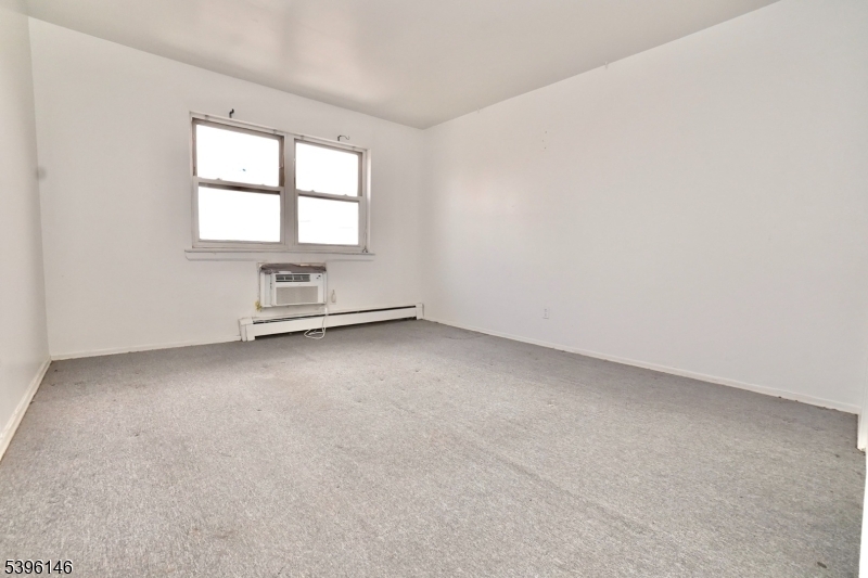 114 32nd Street, Unit 30 Union City, NJ 07087 - Photo 8 of 20 an empty room with windows