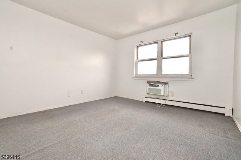 114 32nd Street, Unit 30 Union City, NJ 07087 - Photo 9 of 20 an empty room with a window