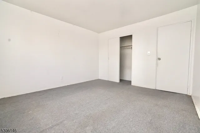 a view of an empty room and closet area