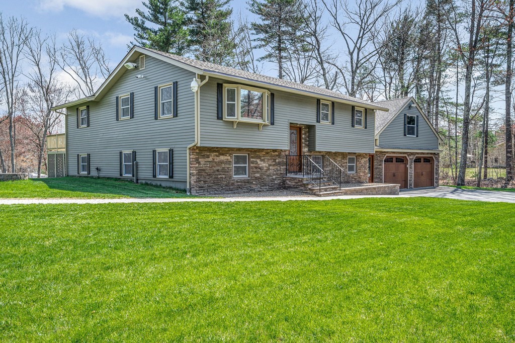 23 Lane Road Pelham, NH 03076 - Photo 1 of 42 a front view of house with yard and green space