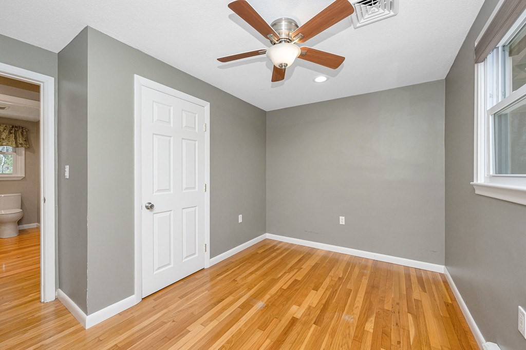 23 Lane Road Pelham, NH 03076 - Photo 11 of 42 wooden floor in an empty room with a window