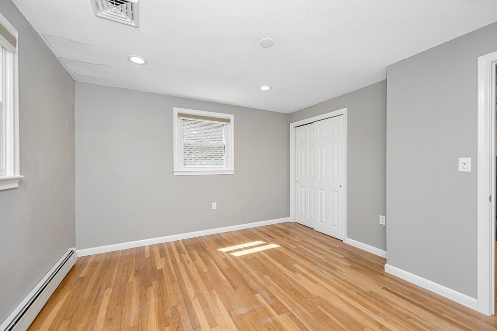 23 Lane Road Pelham, NH 03076 - Photo 12 of 42 a view of an empty room with wooden floor and a window