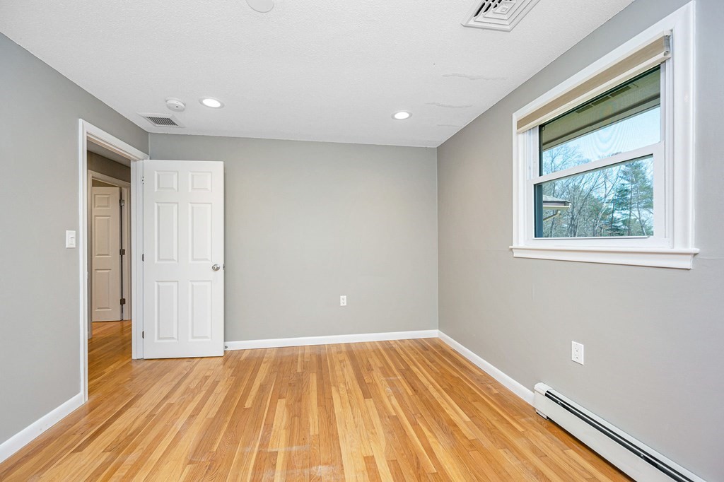 23 Lane Road Pelham, NH 03076 - Photo 13 of 42 a view of empty room with wooden floor