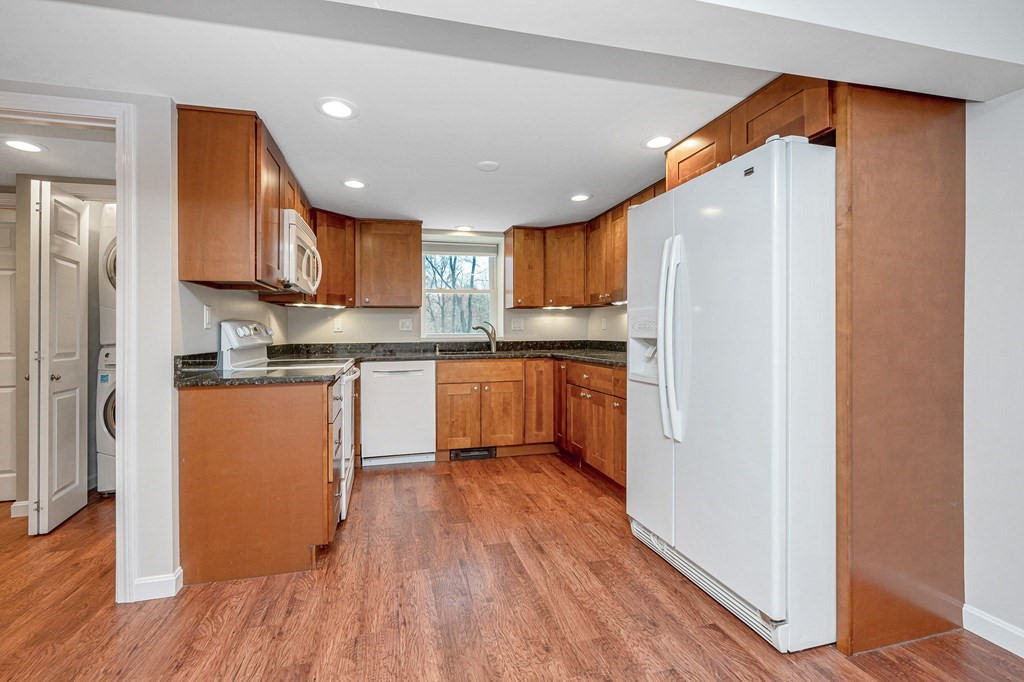 23 Lane Road Pelham, NH 03076 - Photo 15 of 42 a kitchen with stainless steel appliances granite countertop a refrigerator a sink dishwasher and a stove with wooden floor