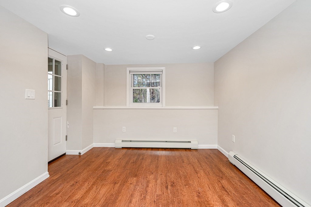 23 Lane Road Pelham, NH 03076 - Photo 17 of 42 an empty room with wooden floor and windows