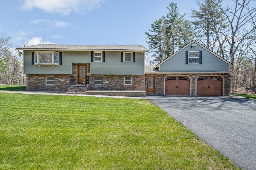 23 Lane Road Pelham, NH 03076 - Photo 2 of 42 a front view of a house with yard and green space