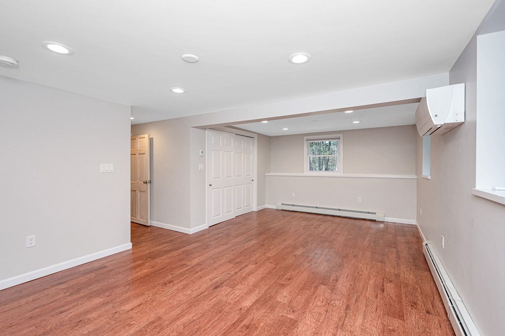 23 Lane Road Pelham, NH 03076 - Photo 22 of 42 a view of an empty room with wooden floor and a window