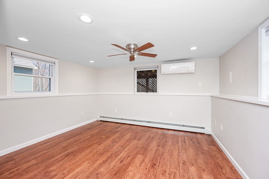 23 Lane Road Pelham, NH 03076 - Photo 23 of 42 an empty room with wooden floor and a ceiling fan