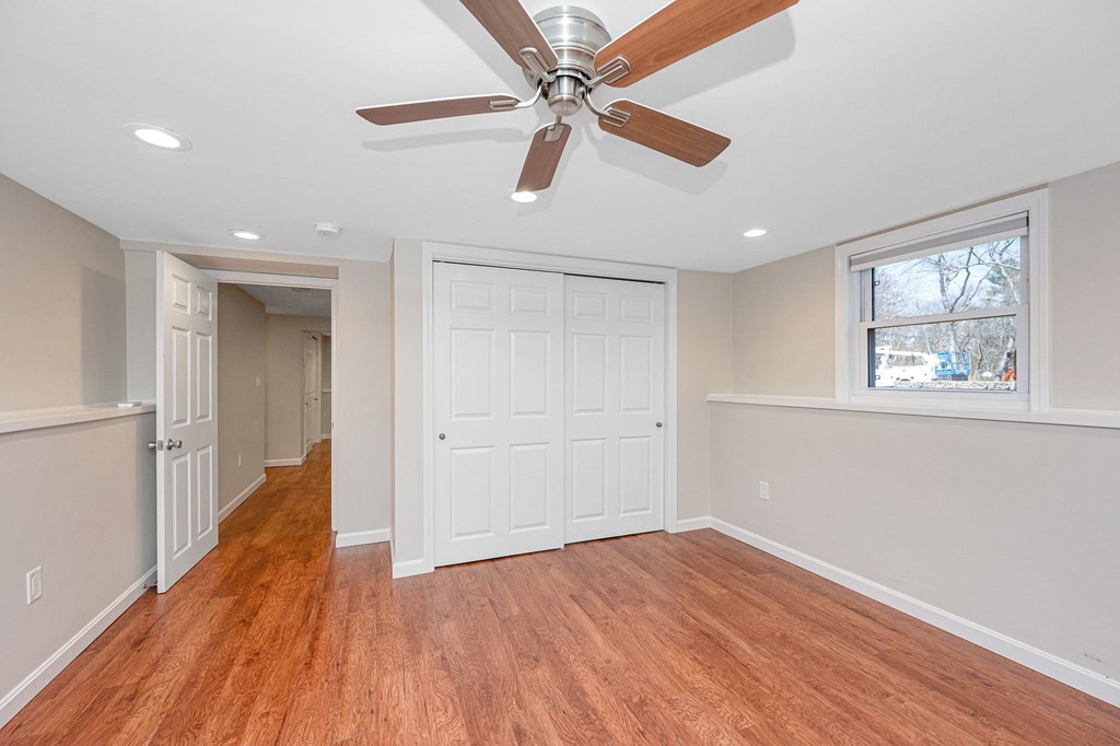 23 Lane Road Pelham, NH 03076 - Photo 24 of 42 a view of empty room with wooden floor and ceiling fan