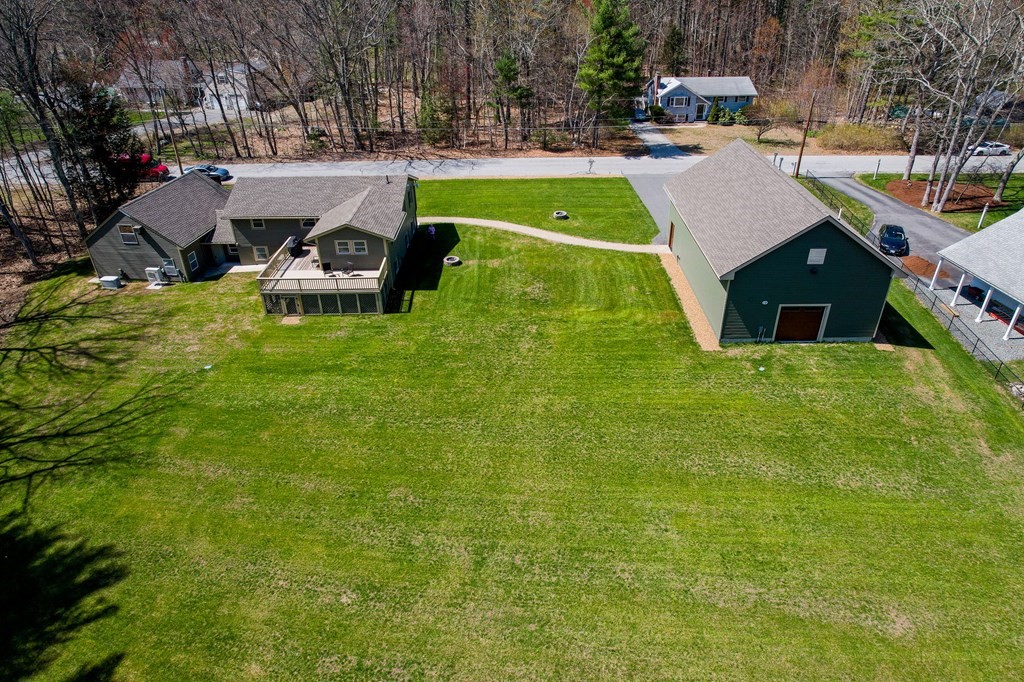 23 Lane Road Pelham, NH 03076 - Photo 39 of 42 a view of a swimming pool with lawn chairs and plants