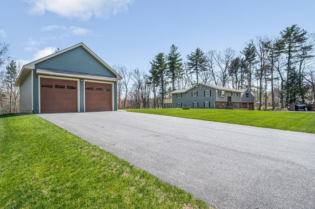 23 Lane Road Pelham, NH 03076 - Photo 42 of 42 a view of a house with a yard and palm trees